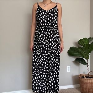 Flowy black midi dress with polka dots and slit